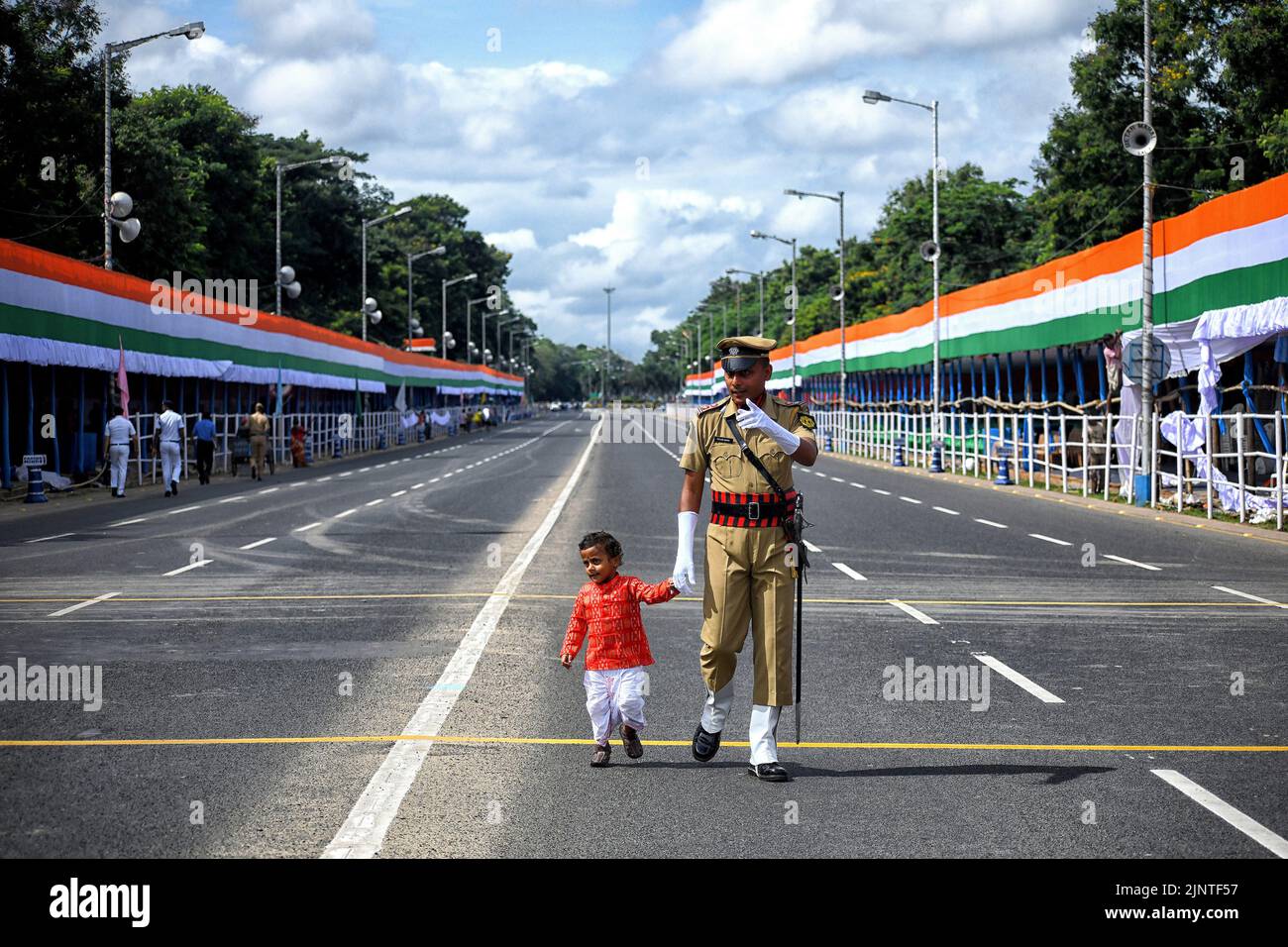 A little child seen with his father who is part of the Kolkata police armed force during the Independence day Final Dress Rehearsal. India prepares to celebrate the 75th Independence day on 15th August 2022 as part of the Azadi Ka Amrit Mahotsav celebration. Stock Photo