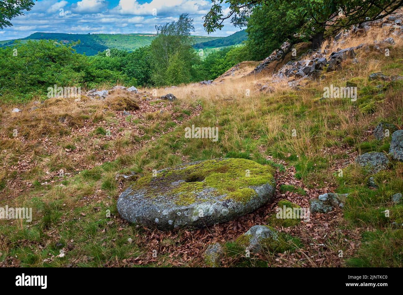 Abandoned handmade millstone lying on the ground at Dobb Edge Quarry