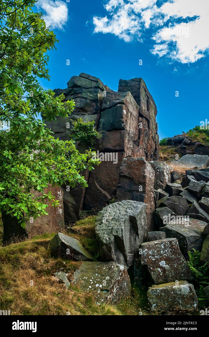 Large pillar of gritstone rock left unquarried with a broken millstone
