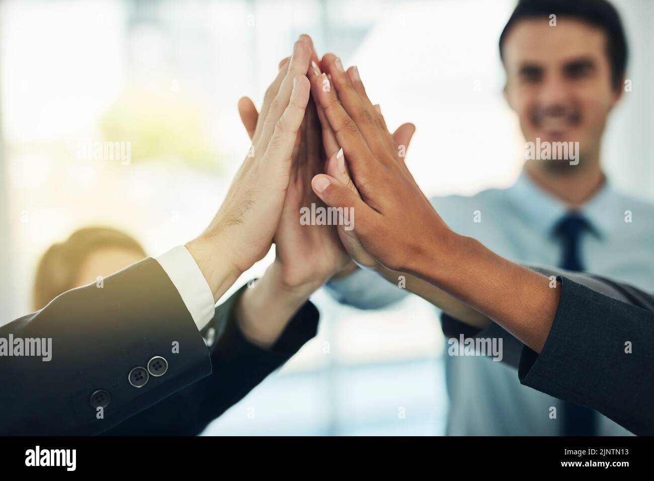The best work is teamwork. a group of businesspeople joining their hands in solidarity. Stock Photo