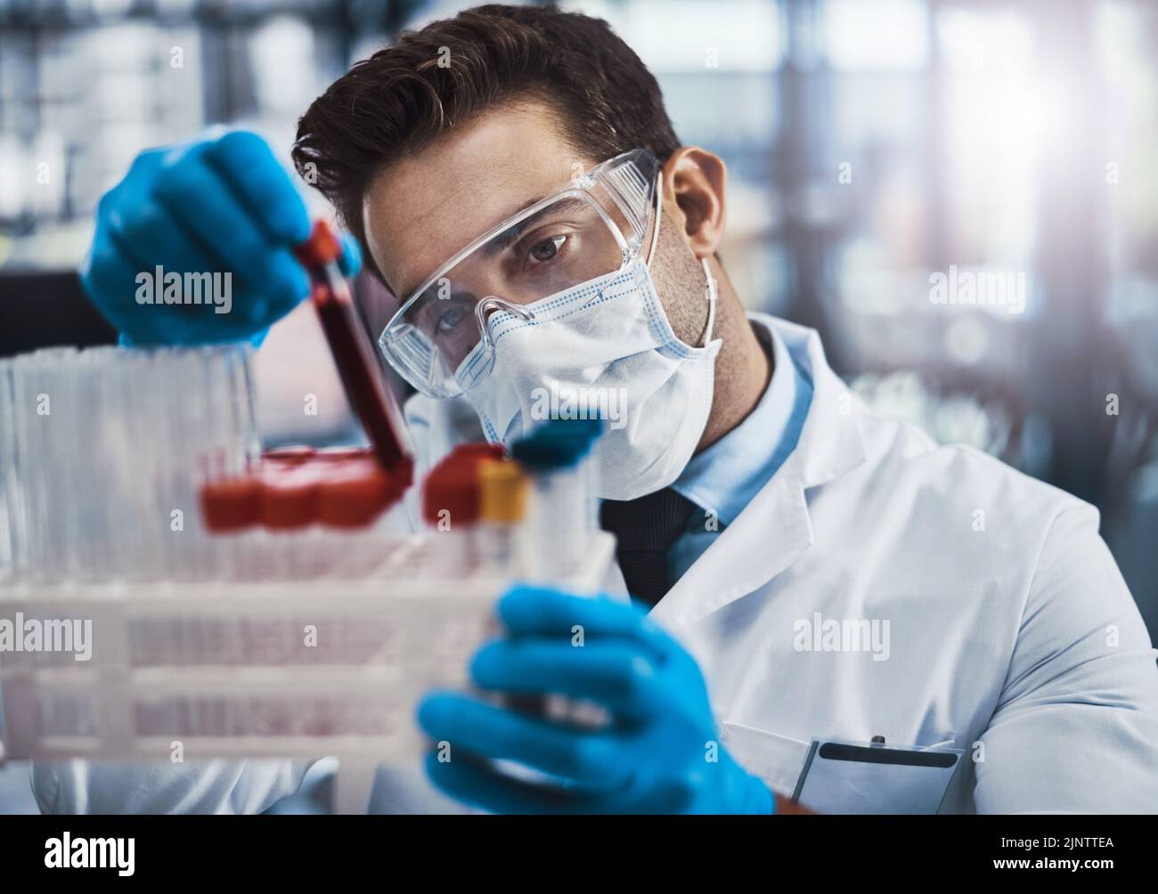 With science its all about the correct ratios. a young male scientist working in a lab. Stock Photo