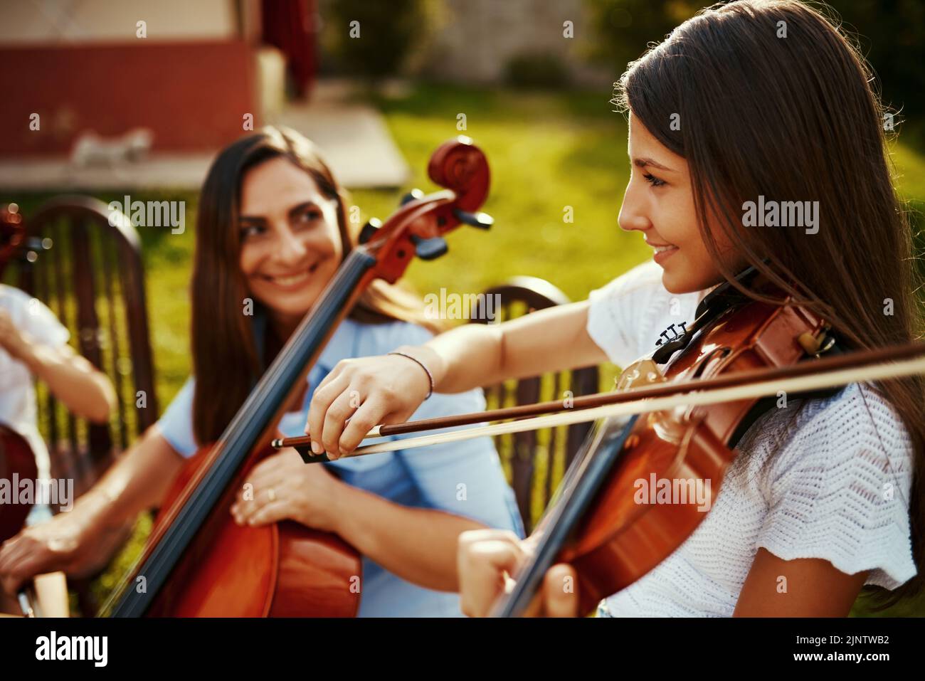 Ive learnt my love for music from my mother. a beautiful mother playing instruments with her adorable daughter outdoors. Stock Photo