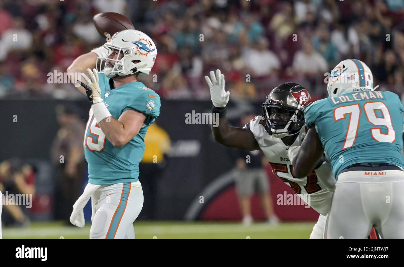 Tampa, United States. 13th Aug, 2022. Miami Dolphins' Larnel Coleman (79) blocks Tampa Bay Buccaneers' Jordan Young (57) as quarterback Skylar Thompson (19) makes a pass during the first half of their preseason game at Raymond James Stadium in Tampa, Florida on Saturday, August 13, 2022. Photo by Steve Nesius/UPI Credit: UPI/Alamy Live News Stock Photo