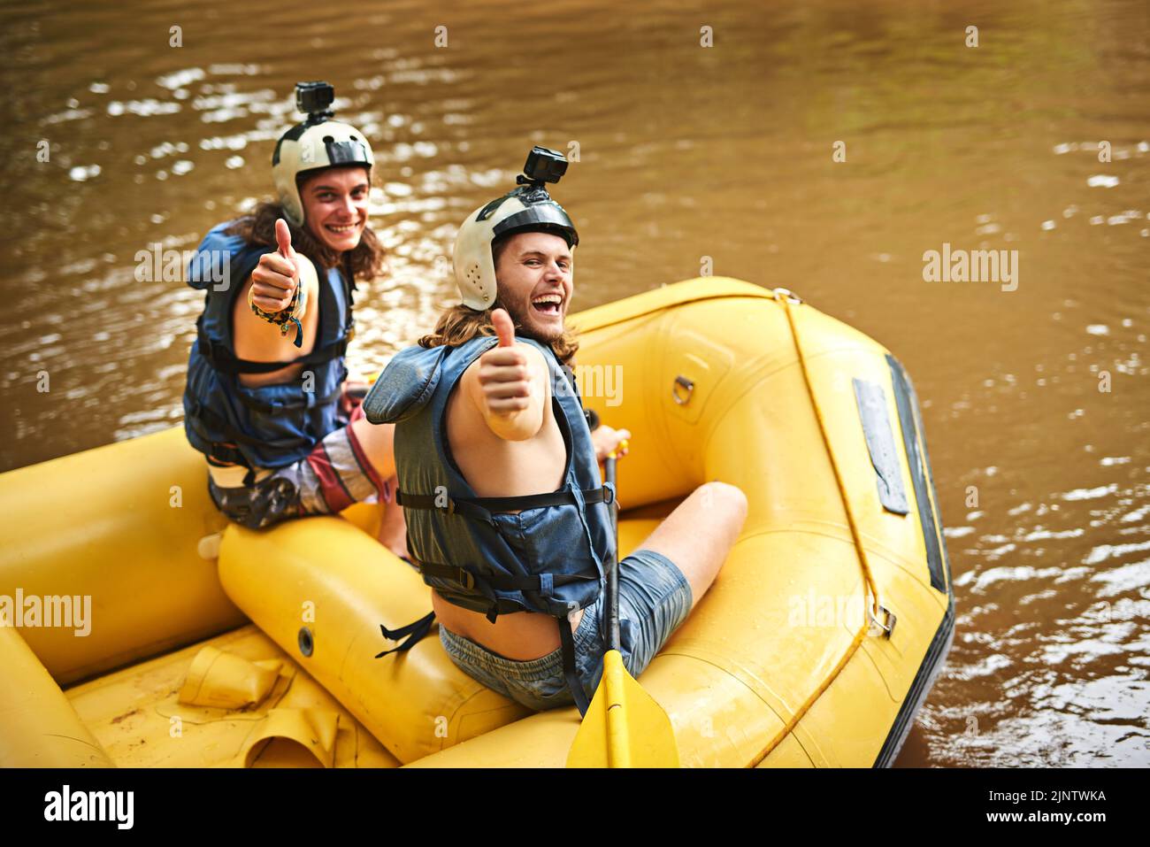 We made it to the bottom. Rearview portrait of two young friends giving ...