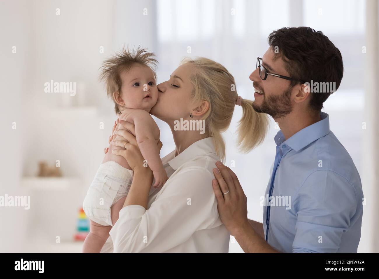 Young 30s loving parents and newborn at home Stock Photo