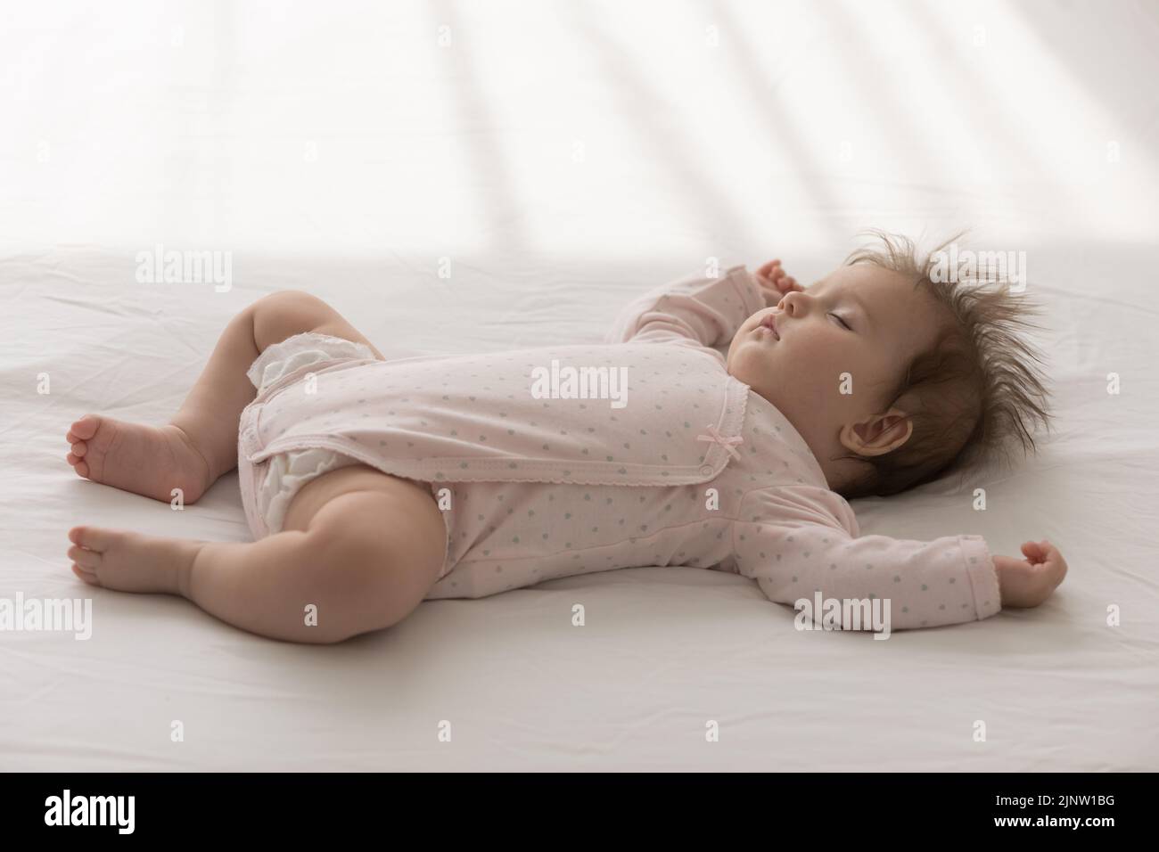Close up shot peaceful baby sleeping lying in bed Stock Photo