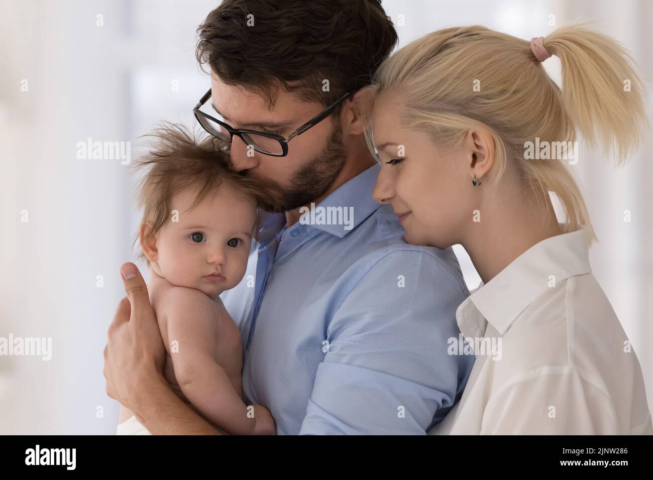 Happy young parents and newborn baby at home, closeup Stock Photo