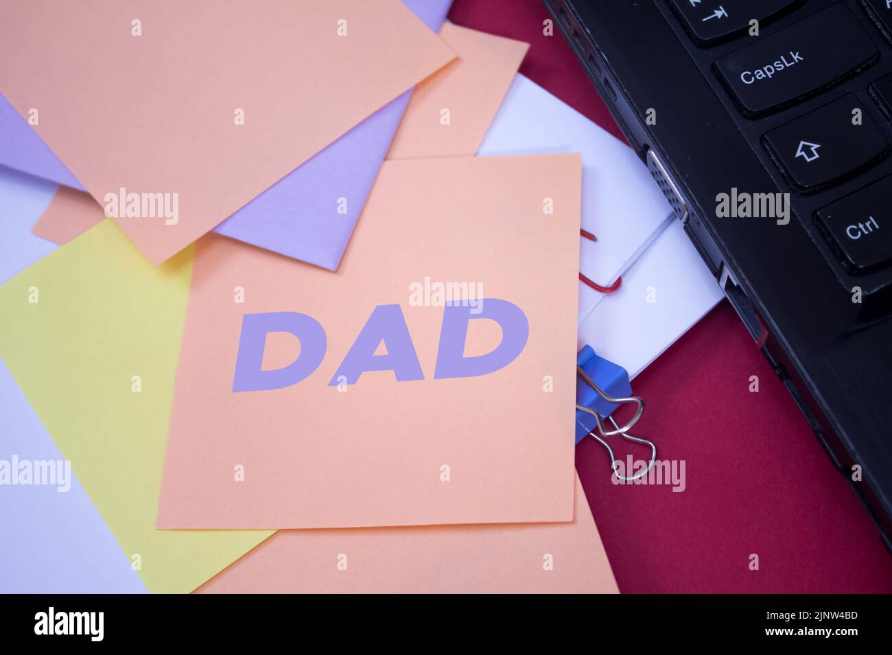 Dad. Text on adhesive note paper. Event, celebration reminder message. Stock Photo