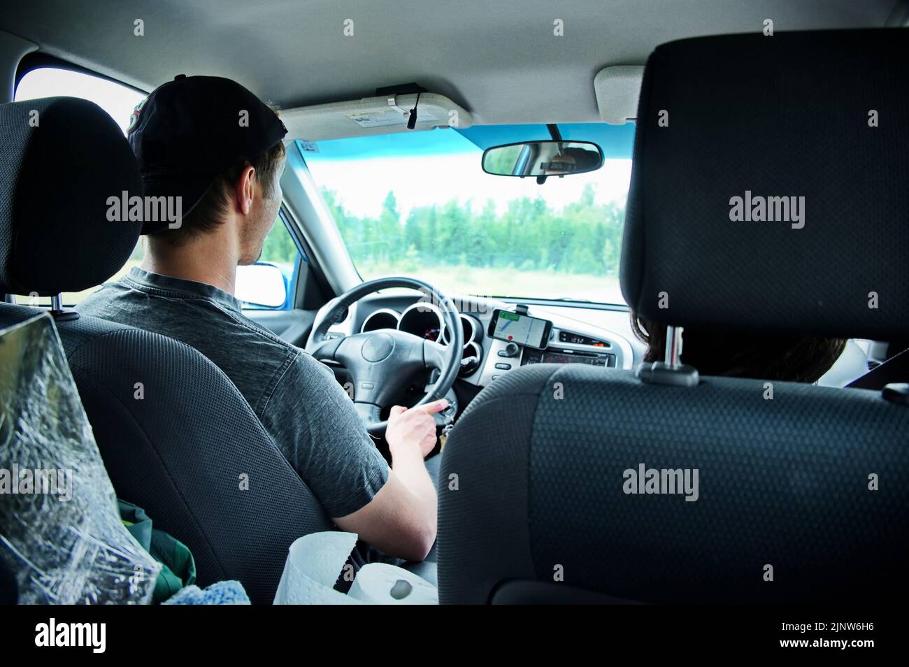 Mature man driving a car and using mobile navigation Stock Photo