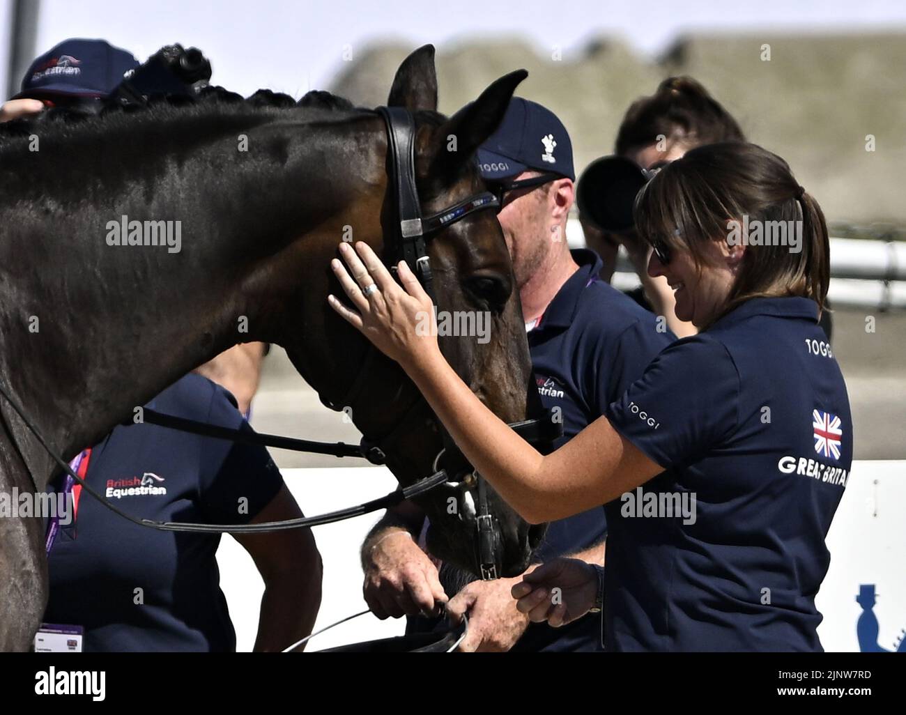 Herning. Denmark. 13 August 2022. World Equestrian Games.KEYSTONE DAWN CHORUS gets a welcoming cuddle at the end of the test in the FEI Para Dressage Team championships - Grade III. Stock Photo