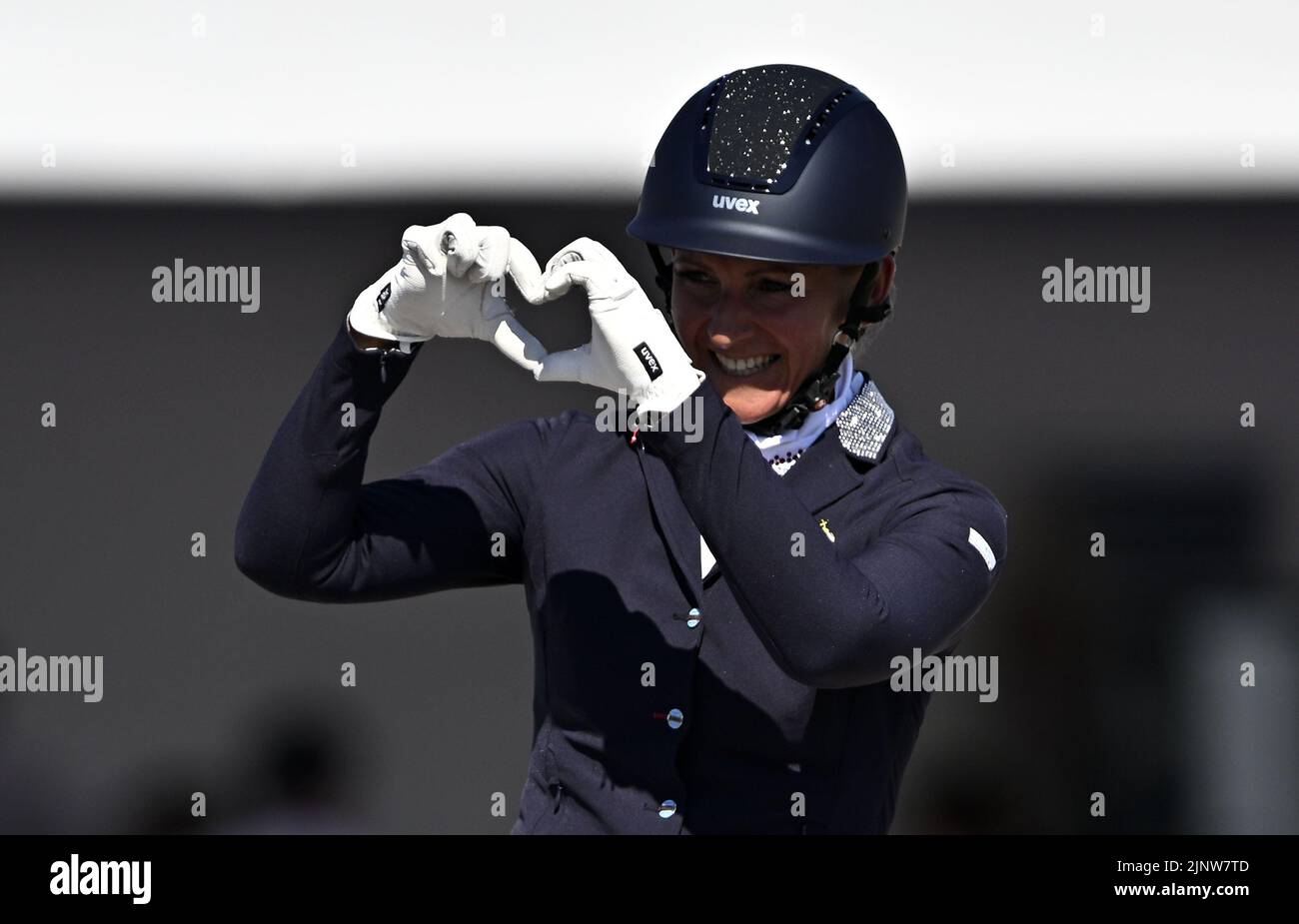 Herning. Denmark. 13 August 2022. World Equestrian Games.Ildikó Fonyódi (HUN) riding SIR SINCERE makes a heart shape with her hands at the end of her teast in the FEI Para Dressage Team championships - Grade III. Stock Photo