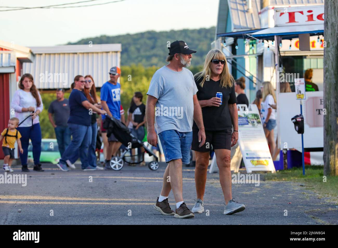 People are seen walking on the midway at the MontourDeLong Community