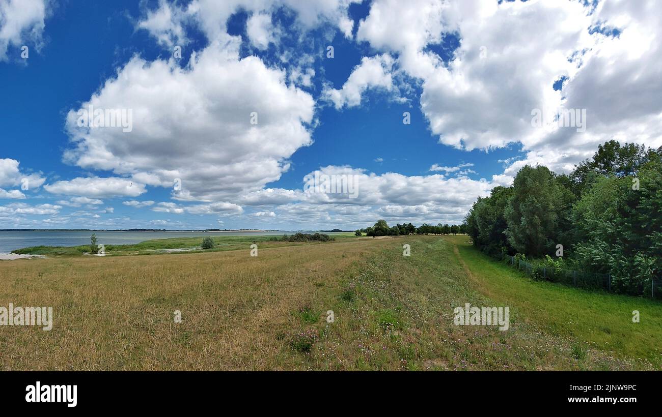 Scenic clouds over coast at the Baltic Sea near Greifswald, Germany. Stock Photo