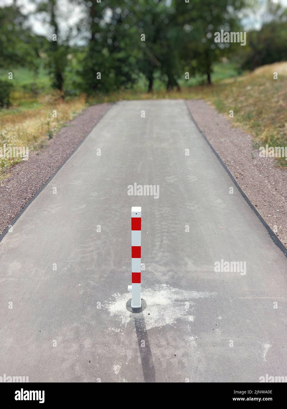 End of a small road with a red and white bollard in Germany. Stock Photo