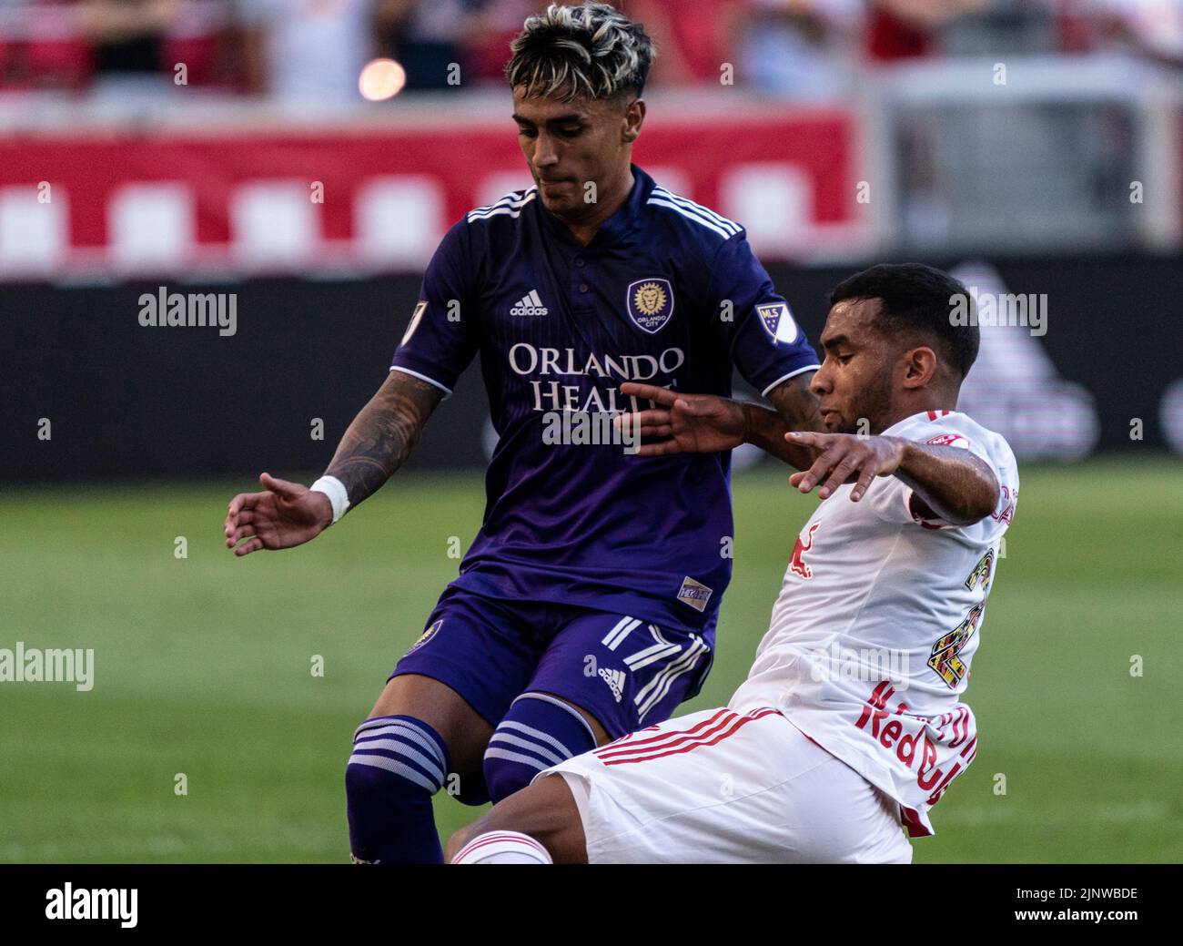 Harrison, NJ - August 13, 2022: Cristian Casseres Jr (23) of Red Bulls and Facundo Torres (17) of Orlando fight for ball during MLS regular season game at Red Bull Arena Stock Photo