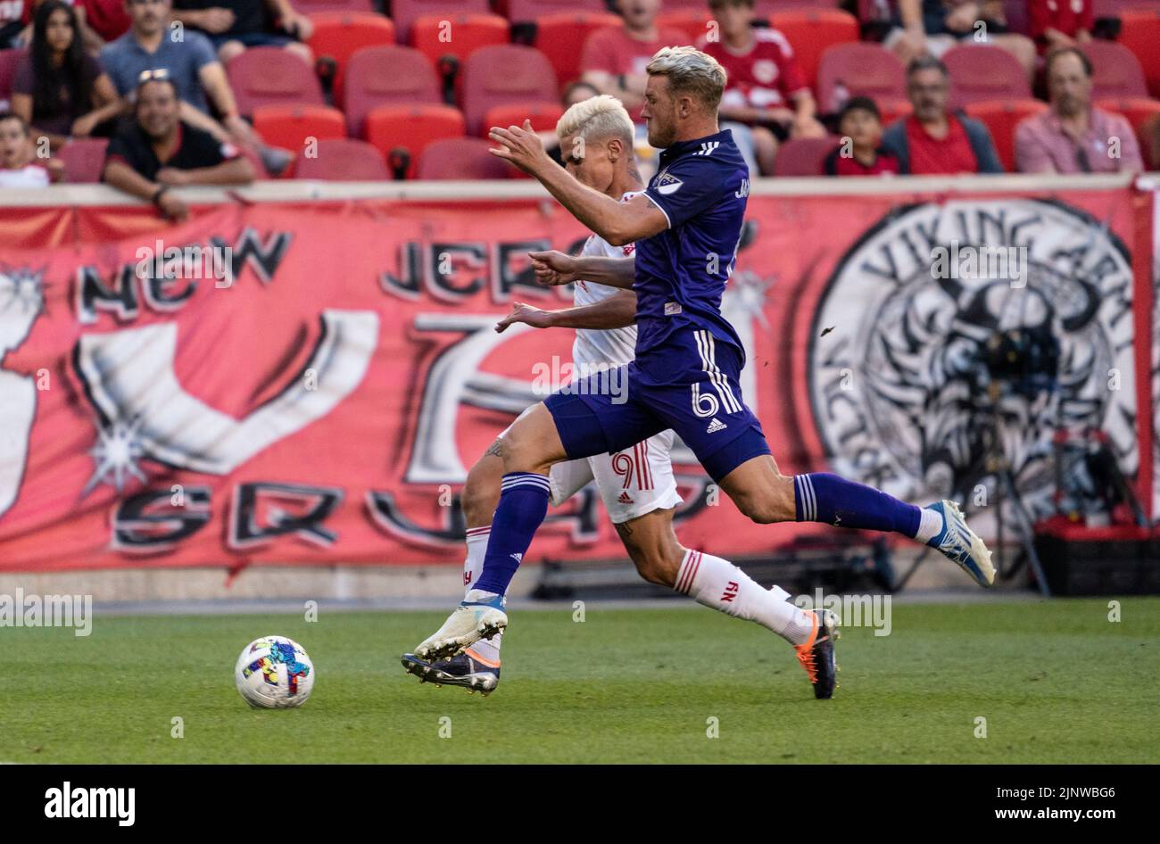 Harrison, NJ - August 13, 2022: Patryk Klimala (9) of Red Bulls and Robin Jansson (6) of Orlando fight for ball during MLS regular season game at Red Bull Arena Stock Photo