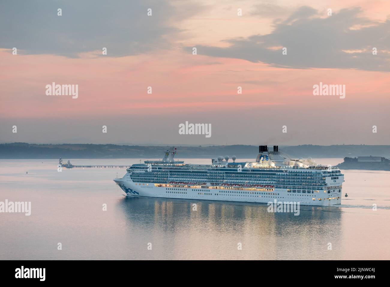 Cork Harbour, Cork, Ireland. 14th August, 2022. Cruise ship Island Princess steams up the harbour at dawn on a cool summer's morning while on her way for a visit to Cobh, Co. Cork, Ireland.  - Picture David Creedon Stock Photo