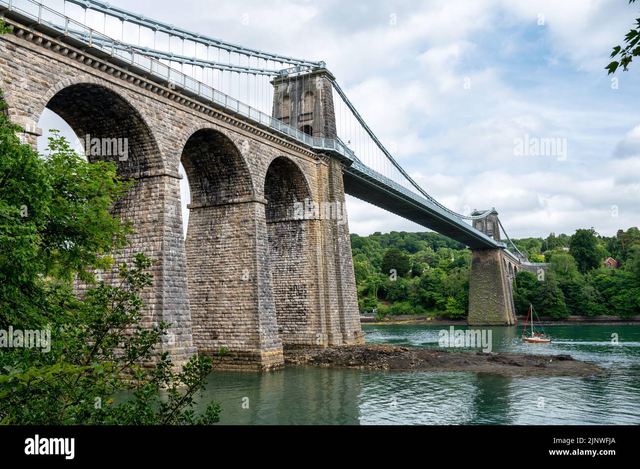 Menai Suspension Bridge built by Thomas Telford that connects the Island of Anglesey to mainland Wales Stock Photo