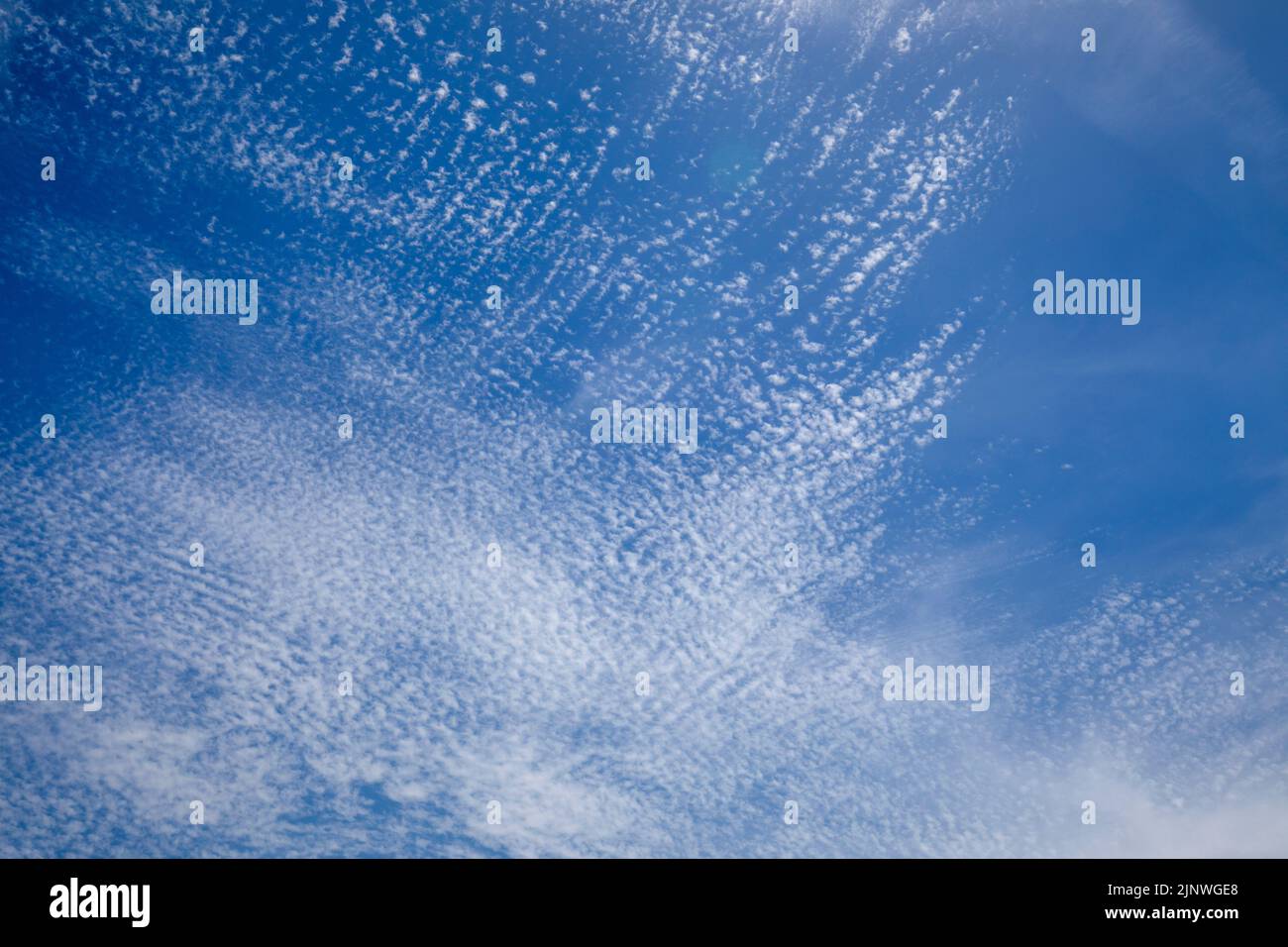 Bright and intense blue sky with white altocumulus clouds Stock Photo