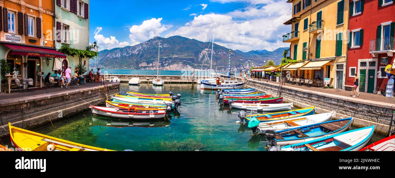 Scenic Lake Lago di Garda, Italy, Charming fishing village with colorful houses and boats - Castelletto di Brenzone. 28/07/2022 Stock Photo