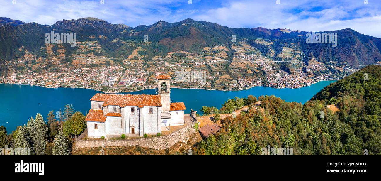 Scenic romantic lakes of Italy - Lago Iseo surrounded by beautiful mountains. Aerial view of small church in top of Monte isola island. Popular touris Stock Photo