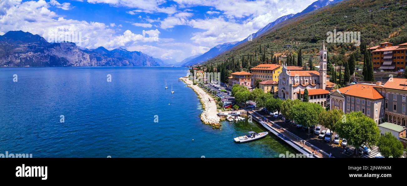 Scenic Lake Lago di Garda, Italy, aerial view of fishing village with colorful houses and boats - Castelletto di Brenzone. Stock Photo