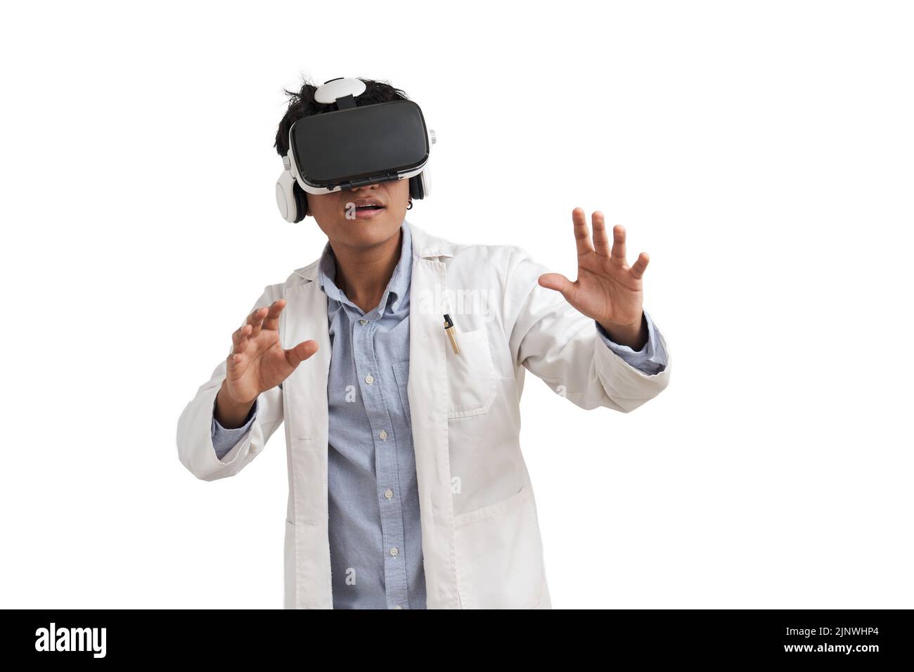 Young peruvian male scientific using virtual reality headset, isolated. Stock Photo