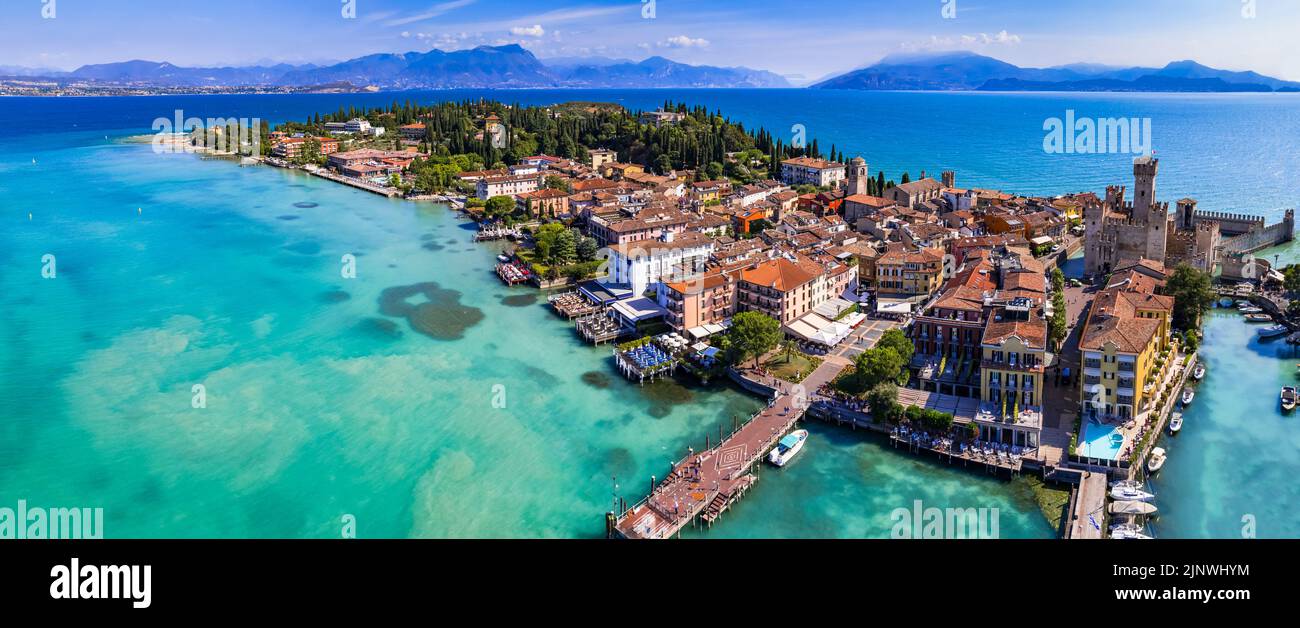Scenic lake Lago di Garda aerial drone view of Sirmione town and medieval castle Scaligero. Italy, Lombardy Stock Photo