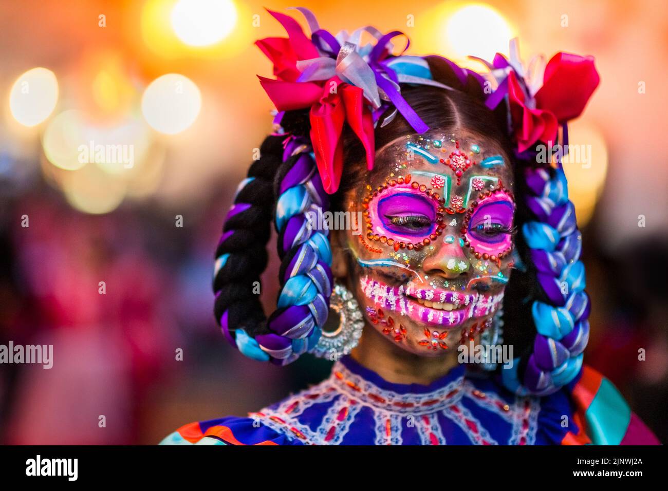 A Mexican girl, dressed as La Catrina, a Mexican pop culture icon, takes part in the Day of the Dead celebrations in Taxco, Mexico. Stock Photo