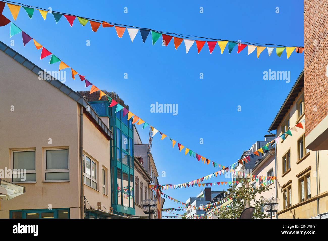Kaiserslautern, Germany - August 2022: Colorful flags decorating the street of city center Stock Photo