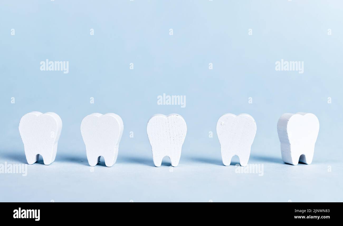 Abstract teeth row on blue background. Dentistry concept. High quality photo Stock Photo