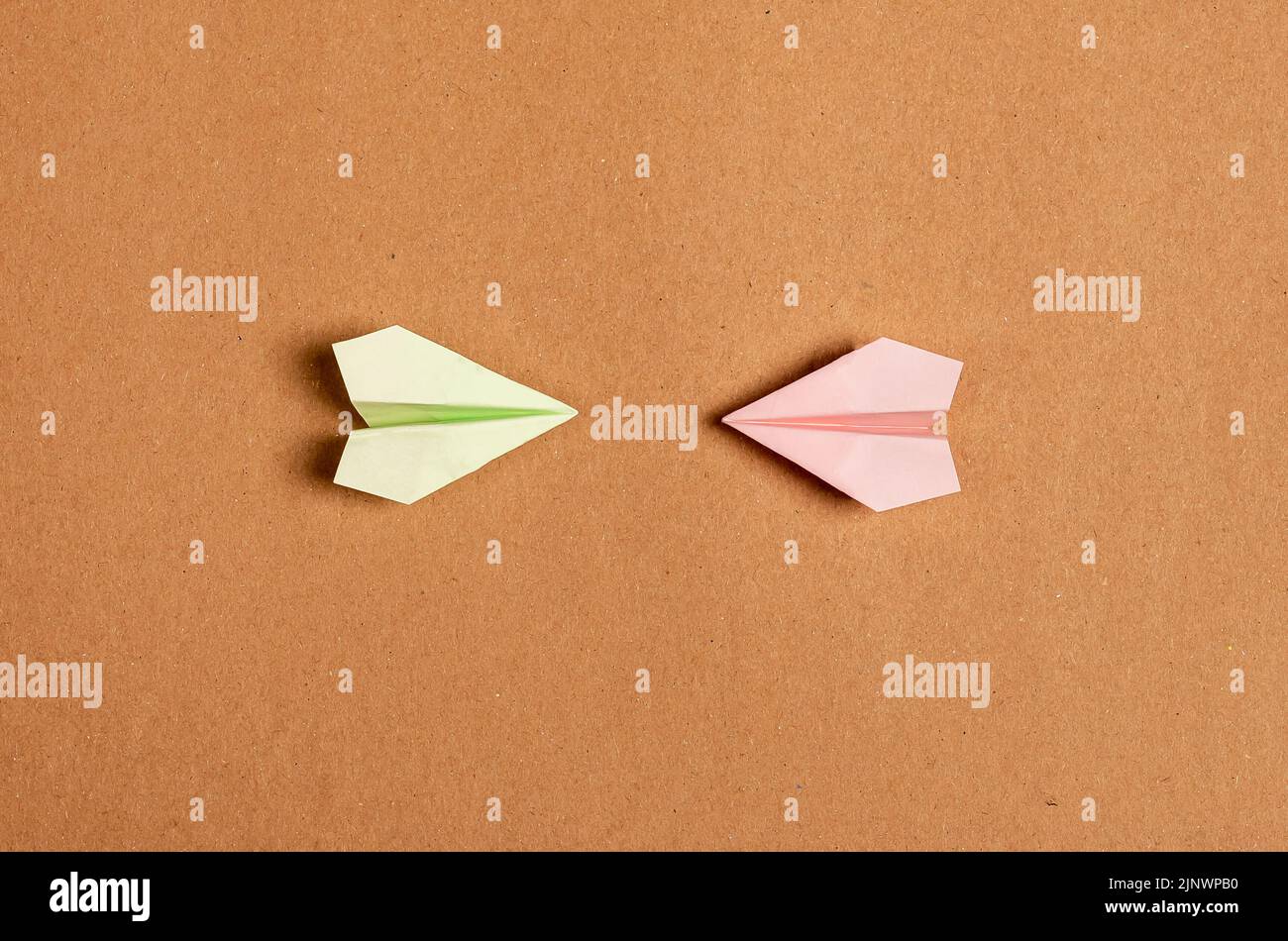 Conflict, confrontation concept. Two paper iar planes in front of each other in battle. High quality photo Stock Photo