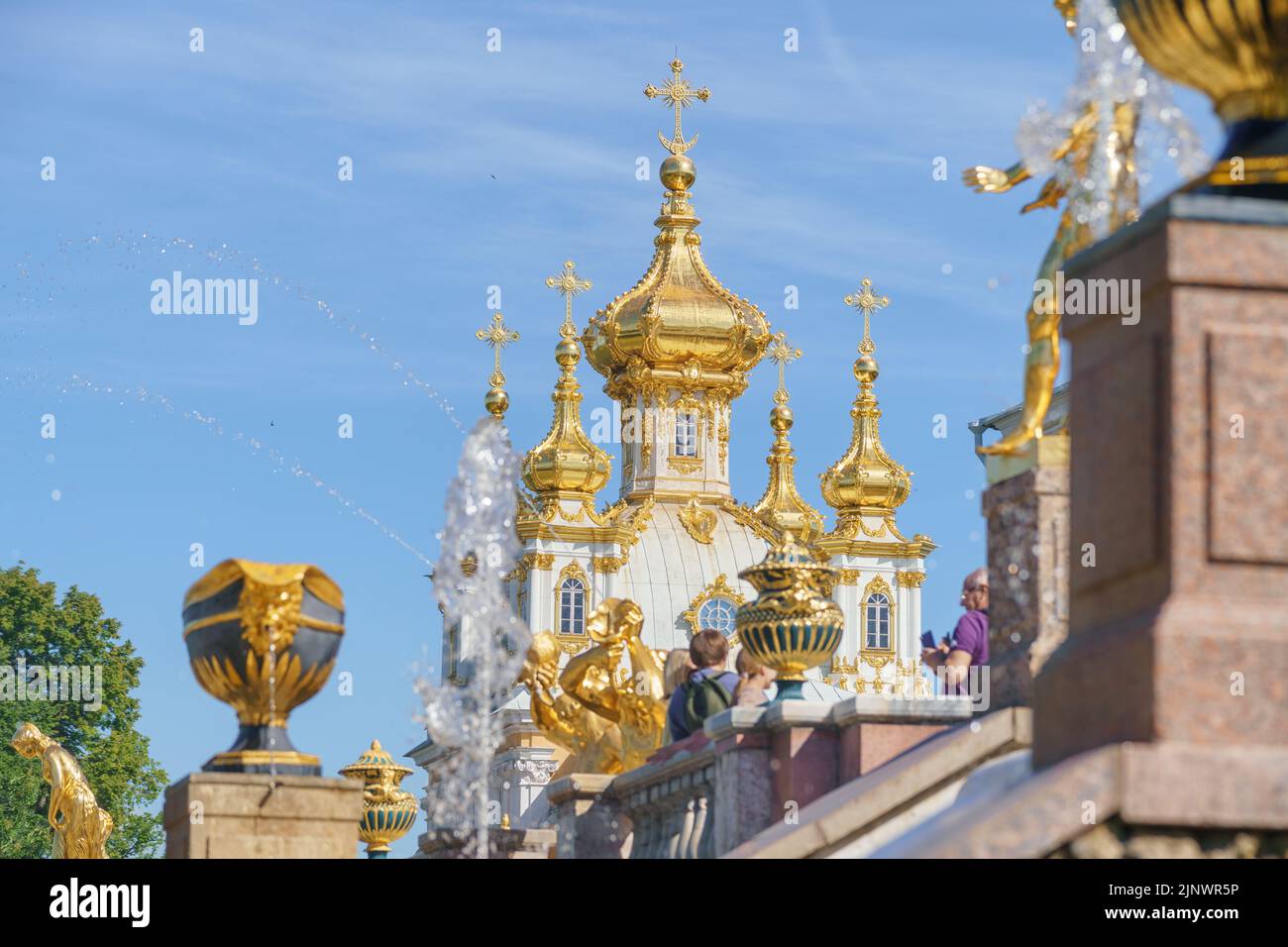 22 June 2022, Peterhof, Saint Petersburg, Russia. Golden domes of the Church of the Grand Palace in the fountain park of Peterhof, Russia Stock Photo