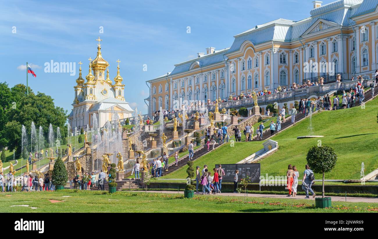 22 June 2022, Peterhof, Saint Petersburg, Russia. Grand Palace, fountains and many tourists  in the lower park of Peterhof on a bright sunny day Stock Photo