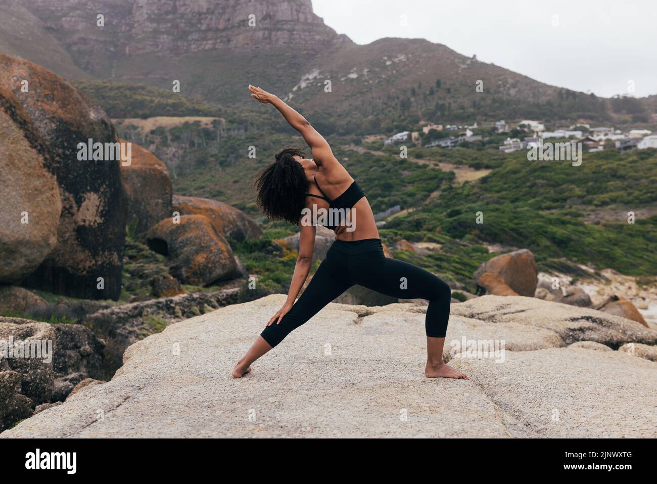 Full length of young fit woman practicing yoga outdoors Stock Photo