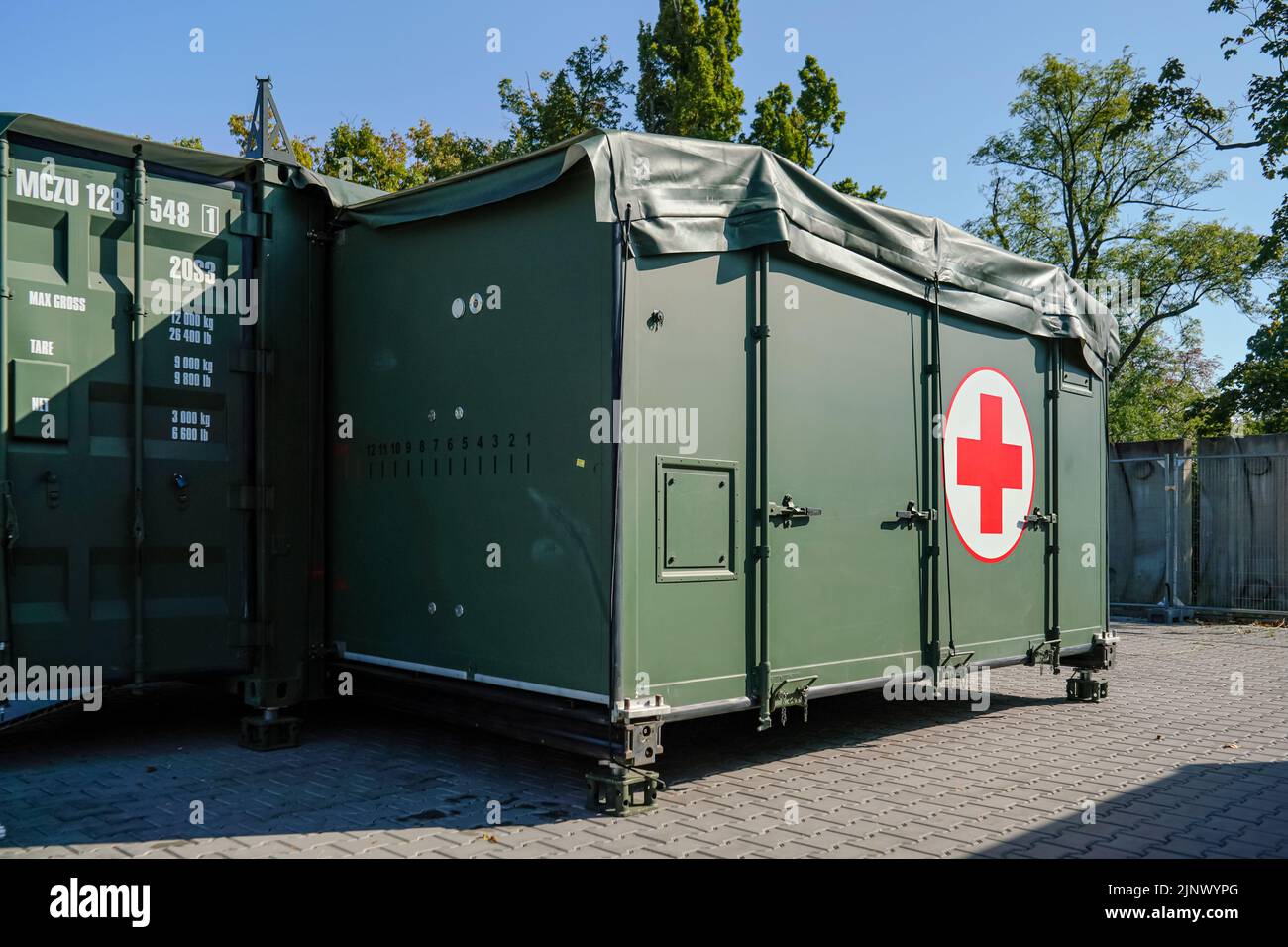 Brno, Czechia - October 08, 2021: Green metal army container boxes with red cross, setup as field ambulance demonstration during IDET military and def Stock Photo