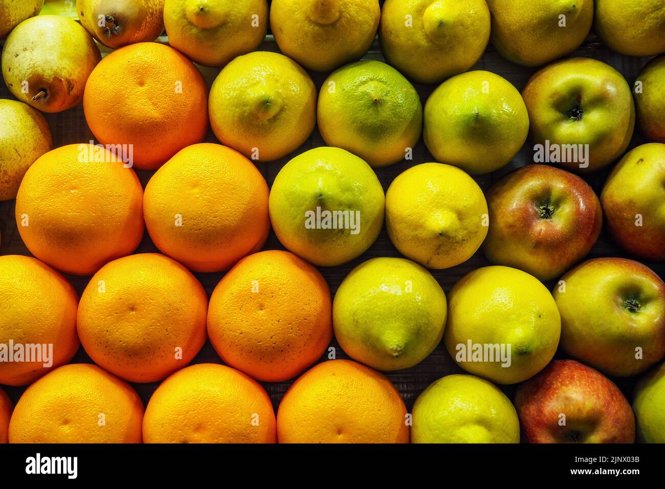 Oranges, pears, lemons and apples arranged nicely on street fruit market in Morocco Stock Photo