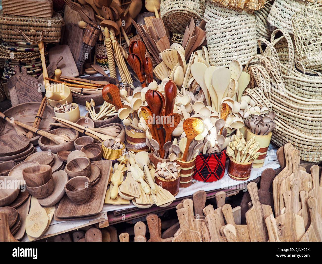 Wooden handmade bowls, spoons, boards, kitchen utensils and baskets on display at street market Stock Photo