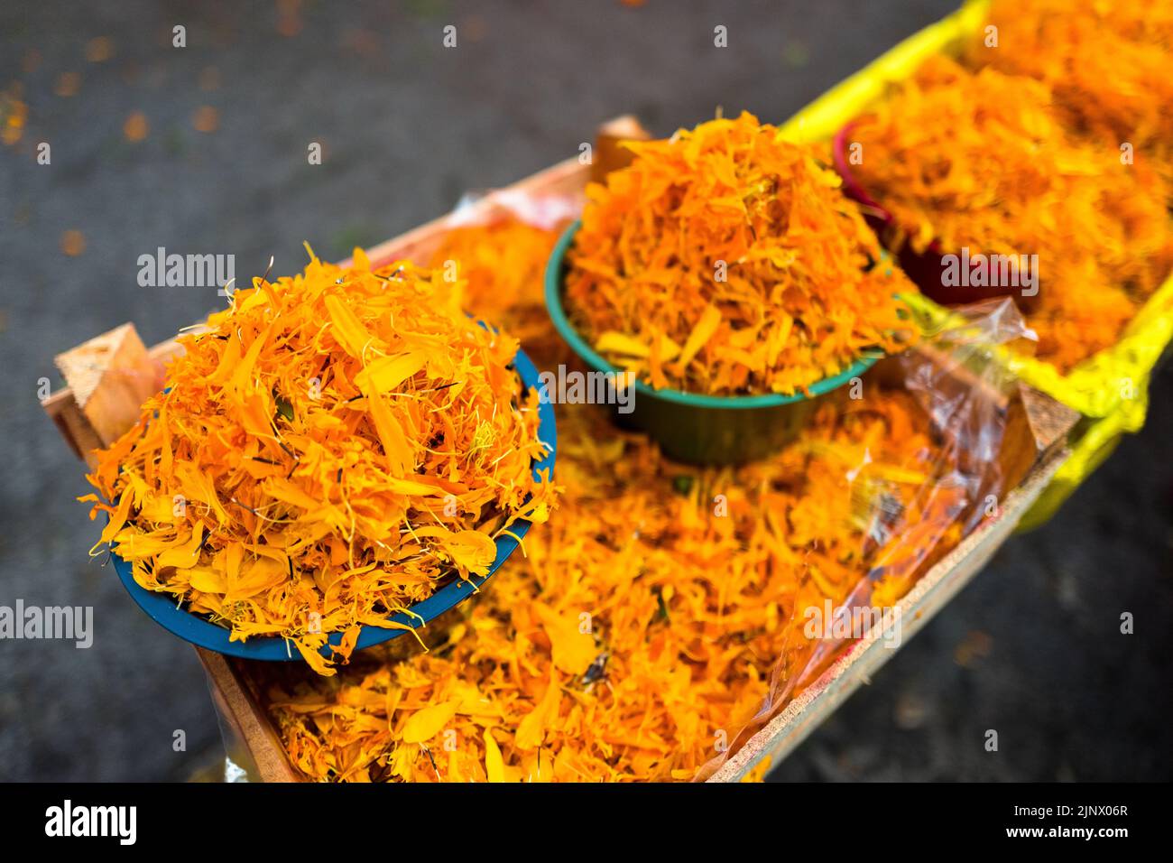 Baskets loaded with the marigold flower petals are seen sold for the