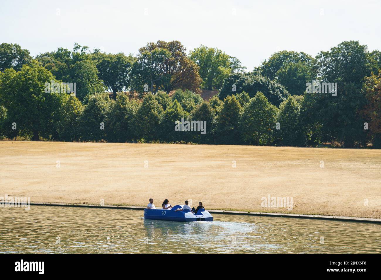 People ride in a pedalo in Greenwich Park, London, as a drought has been declared for parts of