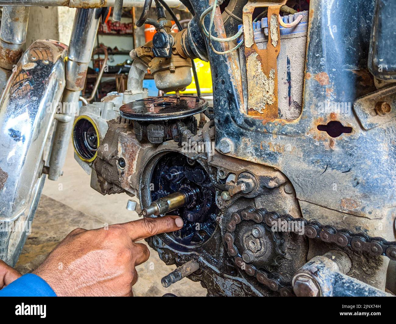 Mechanic i repairing gears of Motorcycle in the workshop Stock Photo ...
