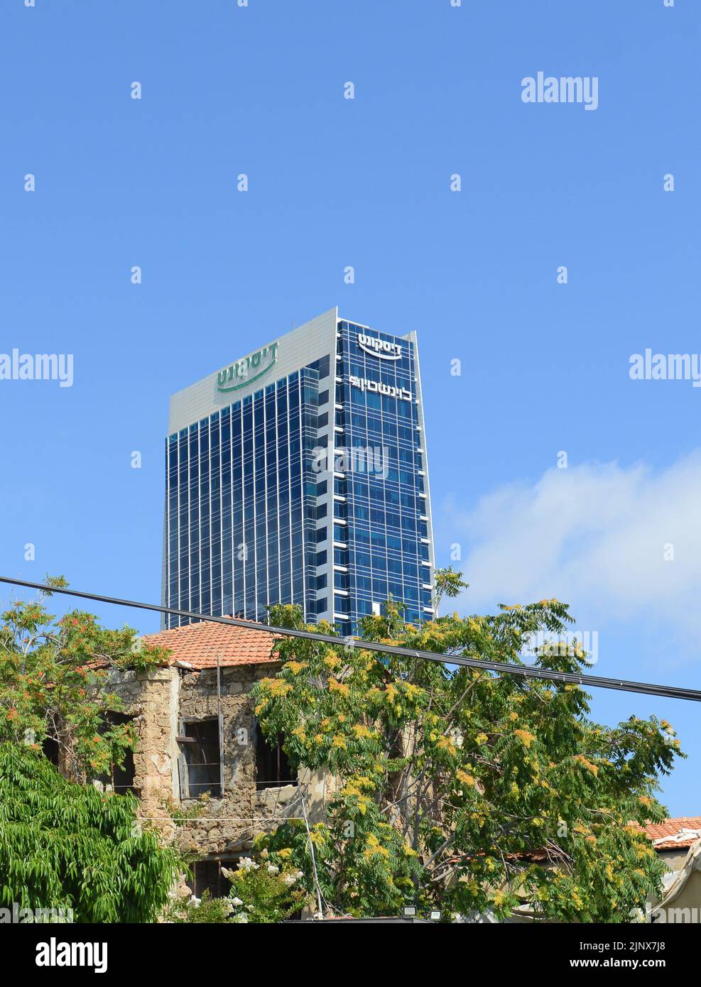 Modern skyscrapers rising around old buildings in Tel-Aviv, Israel. Stock Photo