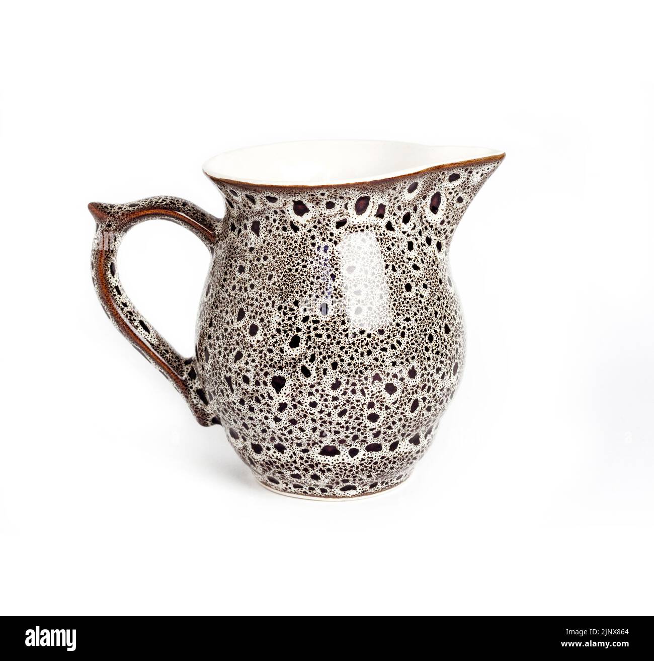 Glazed ceramic milk jar isolated on a white background Stock Photo