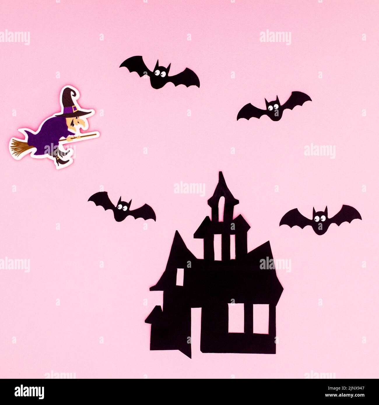 Creative pastel pinkbackground with creepy house bats and witch for Halloween holidays. Flat lay Stock Photo