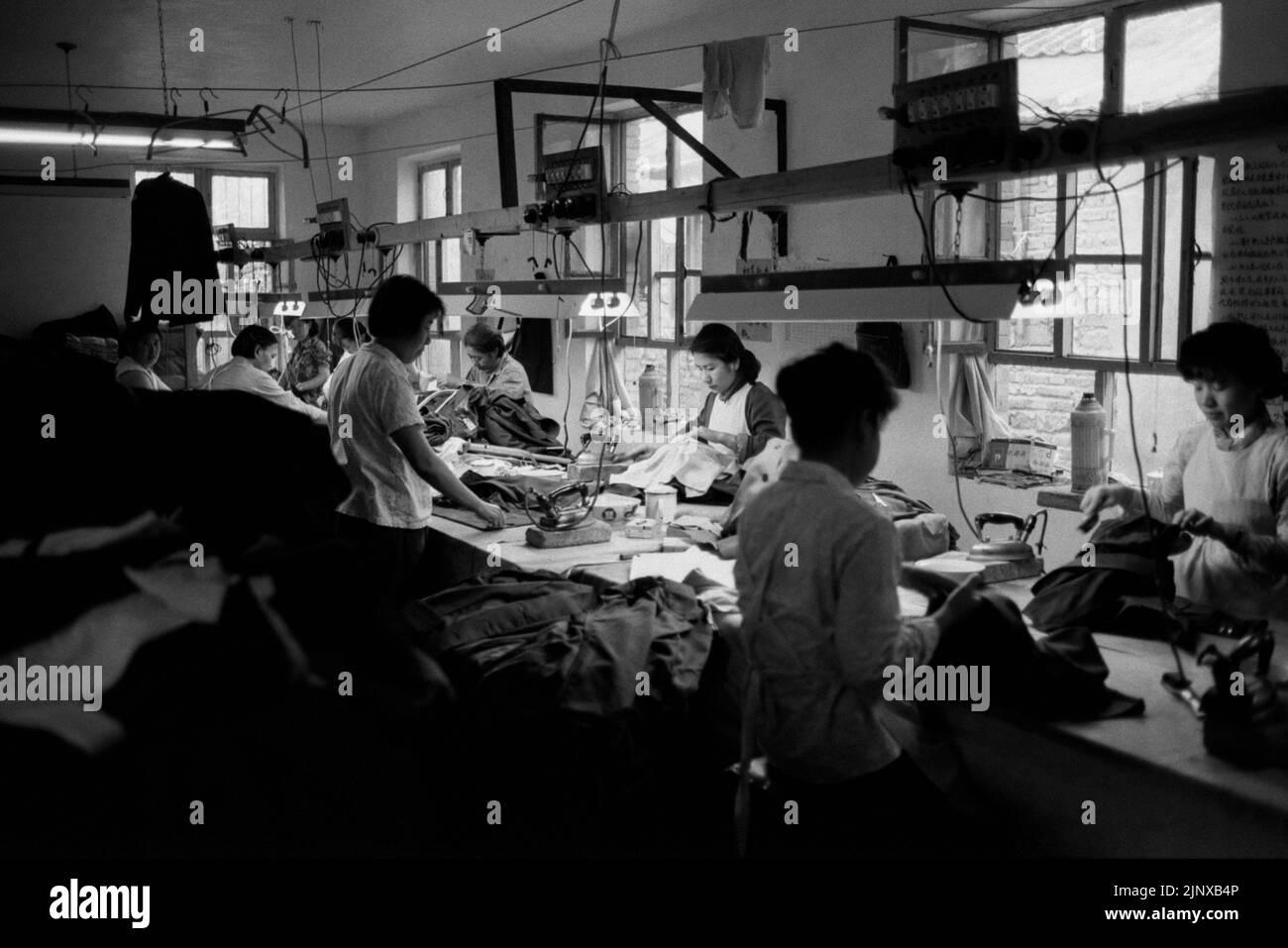 XIAN CHINA textile studio with working needlewoman Stock Photo