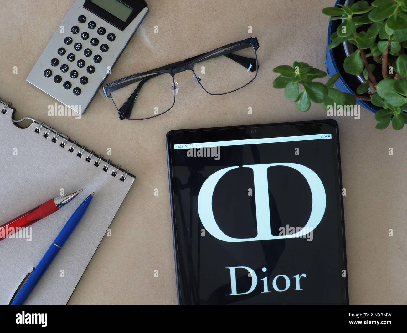 In this photo illustration, Christian Dior SE logo seen displayed on a tablet Stock Photo