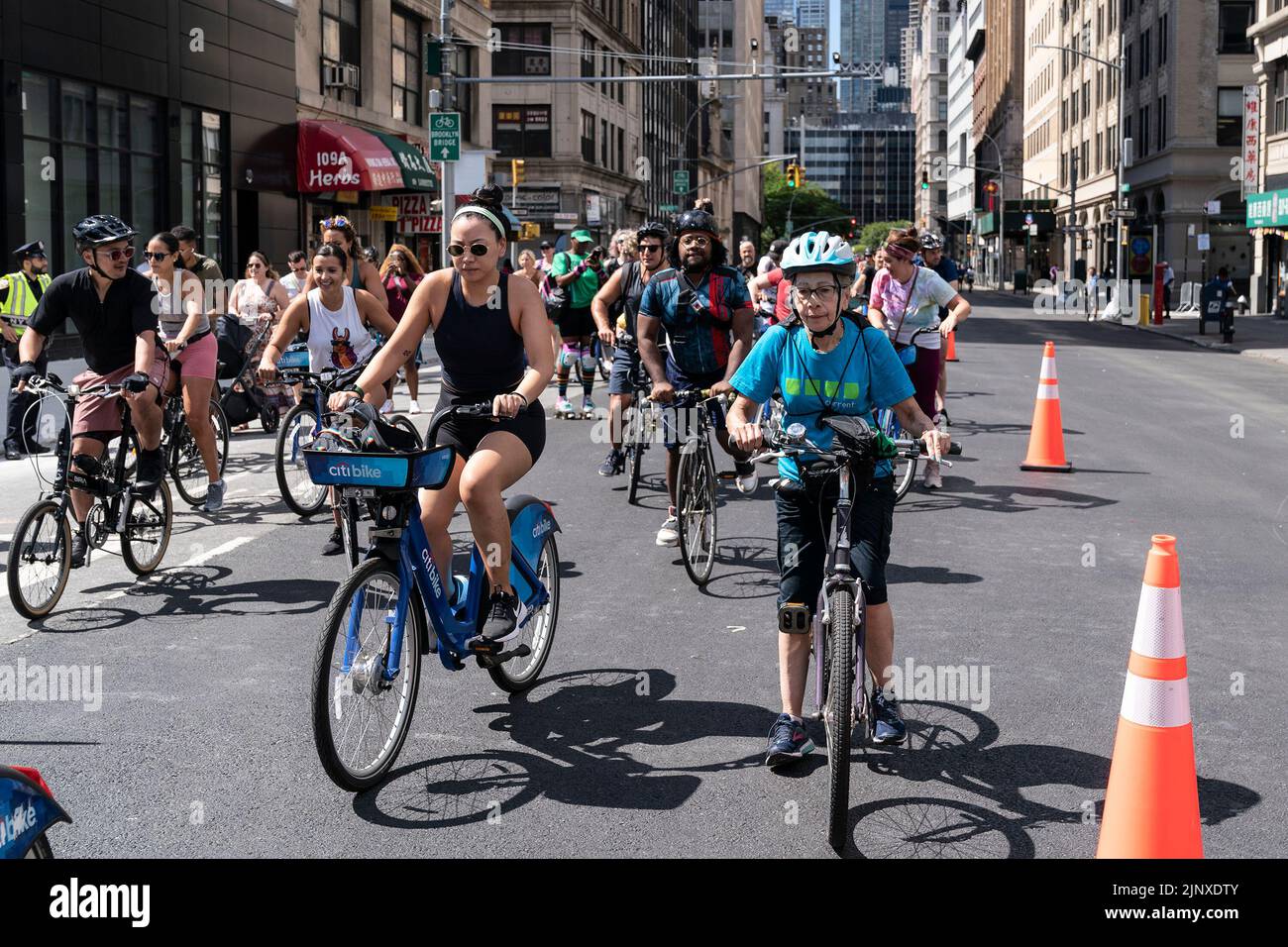 People participate in the Summer Streets program free of car traffic starting at City Hall and along Centre Street and Park Avenue till Harlem. The program includes various physical activities for all ages: Biking, walking and skating along the street free of traffic. At rest stops people can drink water, repair bicycles, rest using hammocks, play for kids, receive free helmets provided by the Department of transportation, free food and drinks samples, and many more. (Photo by Lev Radin/Pacific Press) Stock Photo