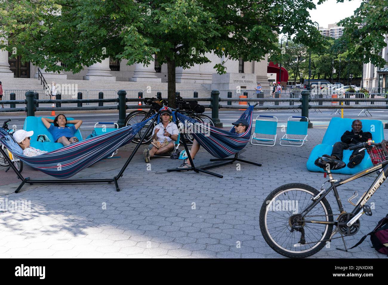 People participate in the Summer Streets program free of car traffic starting at City Hall and along Centre Street and Park Avenue till Harlem. The program includes various physical activities for all ages: Biking, walking and skating along the street free of traffic. At rest stops people can drink water, repair bicycles, rest using hammocks, play for kids, receive free helmets provided by the Department of transportation, free food and drinks samples, and many more. (Photo by Lev Radin/Pacific Press) Stock Photo