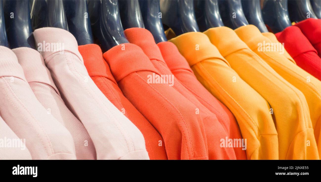 Photo of colorful clothes on hangers in shop Stock Photo
