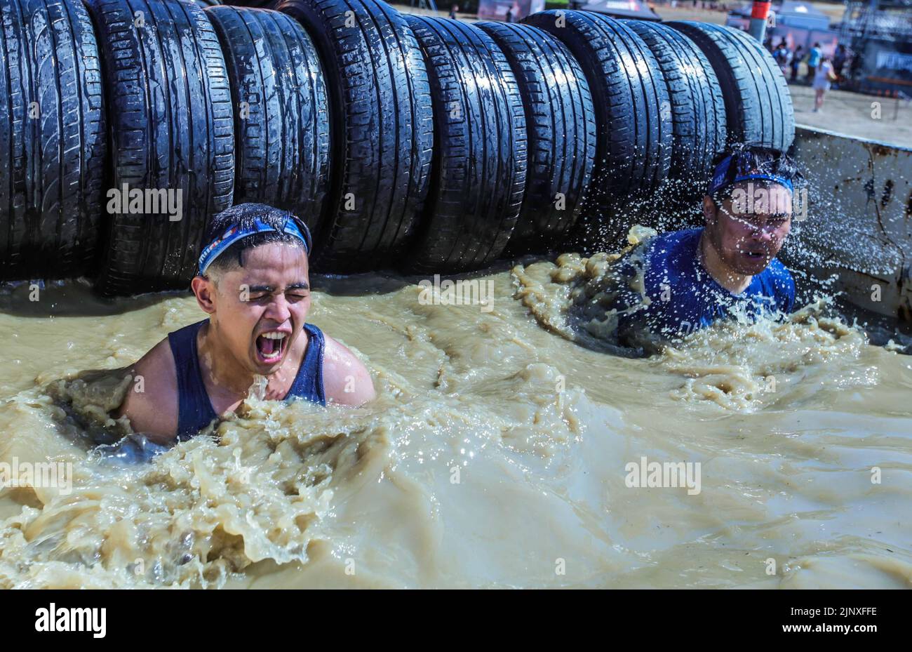 London UK 14 August 2022 Competitors of the Tough Mudder event in Morden Park London cherishing the challenge of conquering the different obstacles put between them and victory, Paul Quezada-Neiman/Alamy Live News Stock Photo